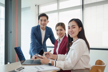 Wall Mural - Diverse business team stacking hands and collaboration and analyze financial data for long term investments