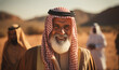 © annebel146 - Portrait smiling arabic oil sheikh with blurred desert on the background. Emirates clothes look at camera happy male saudi arab arabic business muslim traditional sheik posing headscarf sheikh face