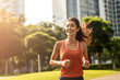 © BrightSpace - Vibrant Midlife Woman Exercising Outdoors: Beautiful Lady portrait people jogging with Freshness in Urban Park with Trees and Buildings with bright sun and nature light, healthy concept, gen ai