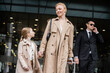 © LIGHTFIELD STUDIOS - personal security, lifestyle, blonde mother with preteen girl holding hands near hotel, successful woman and child, bodyguard in suit standing on blurred background, rich life