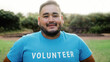 © Vane Nunes - Asian male volunteer working at foundation charity outdoor - Plus size man looking at camera in blue uniform for community donations