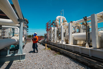 Wall Mural - Male worker inspection at steel long pipes and pipe elbow in station oil factory during refinery valve of visual check record pipeline oil