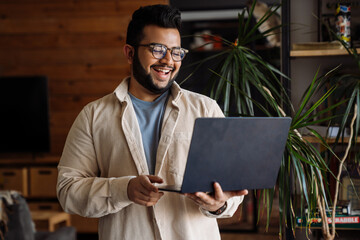 Wall Mural - Business man working on laptop while standing in office