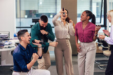 Group Of Professional People Singing Karaoke In The Modern Office
