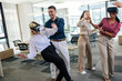 © Mediteraneo - Group of professional people playing with VR glasses on the work in the modern office.Team Building