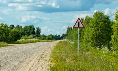 Warning sign on a forest road on a sunny day , backgrounds