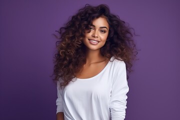 Wall Mural - beautiful young woman standing on a purple background with curly hair and smiling, ai generated, white and purple, vibrant color combinations