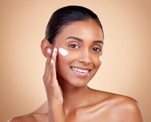 Face, cream and portrait of indian woman, skincare cosmetics and aesthetic dermatology on studio background. Happy young female model, lotion and facial sunscreen for clean beauty, glow and self care