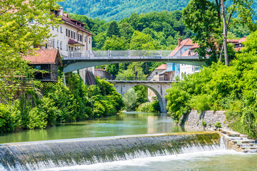 Wall Mural - A view across the Selca Sora river in the old town of Skofja Loka, Slovenia in summertime
