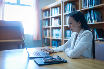 A university lecturer gives an online lecture to students in office