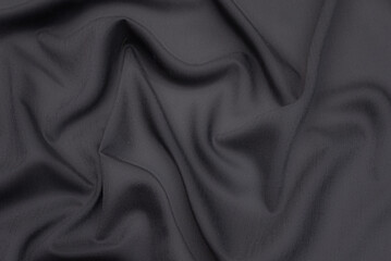 Wall Mural - Black fabric texture background, wavy fabric slippery black color, luxury satin or silk cloth texture.