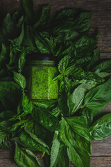 Wall Mural - Pesto sauce in a glass jar. green basil leaves
