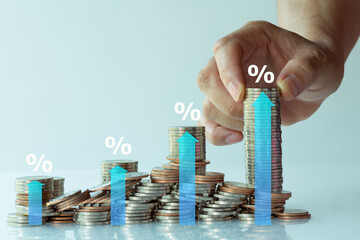 Interest rate and dividend concept. hand of man with percentage symbol and up arrow, Interest rates continue to increase, return on stocks and mutual funds, long term investment for retirement..