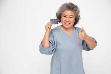 Wall Mural - Portrait of senior asian woman holding credit card and showing on hand isolated on white background