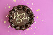 Chocolate birthday cake with happy birthday lettering