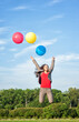 © darkbird - Young beautiful happy business woman with long hair jumping with air balloons outdoor
