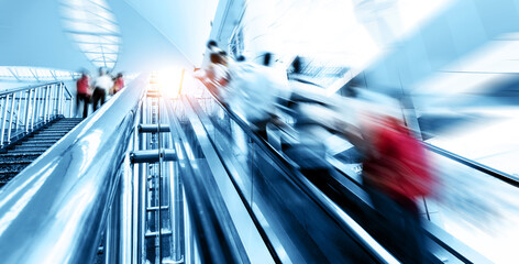 Wall Mural - People rush on escalator motion blurred