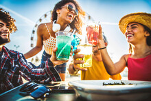 Multiracial Happy Friends Toasting Cocktail Glasses Outdoors At Summer Vacation - Smiling Young People Drinking Alcohol Together Sitting At Bar Table - Beverage Life Style Concept