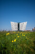 The Beautiful Exterior of the Titanic Museum in Titanic Quarter with beautiful yellow tiny flowers view in its front