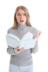 Wall Mural - Shocked young woman reading book on white background