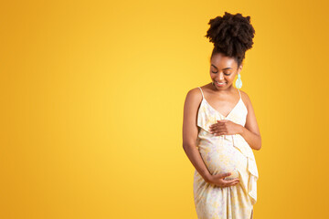 Wall Mural - Glad young black woman touching big belly, feels baby move, enjoy pregnancy