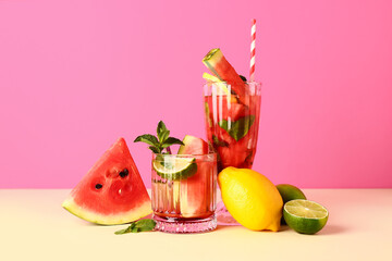 Glasses of fresh watermelon lemonade with lime and mint on yellow table