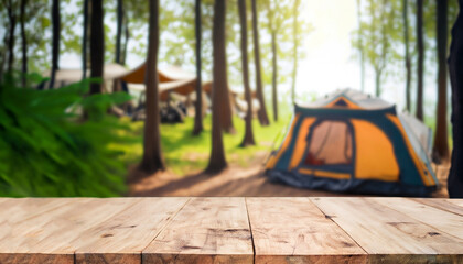 Wood table and Blurred camping and tents in forest.