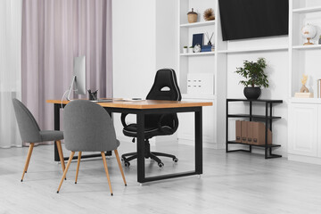 Sticker - Stylish director's workplace with wooden table, tv zone, shelves and comfortable armchairs in room. Interior design