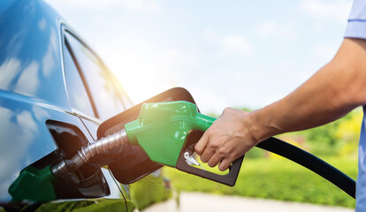 Mand hand refilling the car with fuel