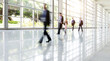 © xy - Group of business people walking in glass building