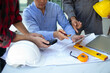 © weerachai - Team Engineer and Architect planing and discuss at Construction Site with blueprint