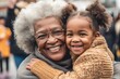 © Alan - little girl hugging grandmother, lovely scene of an african american kid with black grandma, smiling on grandparents day