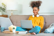 © joyfotoliakid - African American teenage  women sitting on sofa relax enjoying meditation for sleep and peaceful mind in wireless headphones at home.