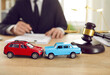 © Studio Romantic - Miniature cars and judge gavel on desk of lawyer or insurer solving problems drivers involved in accident and in need insurance payment or providing services legal customer service. Selective focus
