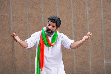 Indian man in traditional wear and giving expression.