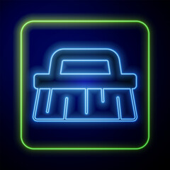 Wall Mural - Glowing neon Brush for cleaning icon isolated on blue background. Vector