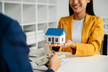  Signing a contract. Client and broker agent, lease agreement, successful deal and  Young business sitting at the desk in office .