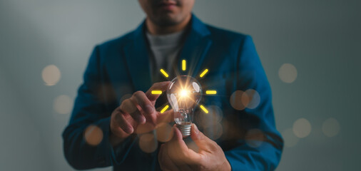 Poster - Creative idea. Concept of idea and innovation, Businessman holding light bulb. Idea concept with innovation and inspiration for business or education, Creative thinking and learning.