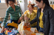 © ReeldealHD images - Young adult females volunteers sorting through second hand vintage thrift clothing