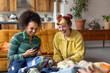 © ReeldealHD images - Friends taking photos of vintage second hand thrift clothes to sell online