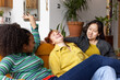 © ReeldealHD images - Group young adult friends laughing together in a shared loft apartment