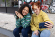 © ReeldealHD images - Two friends taking a selfie on a city break
