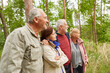 © Robert Kneschke - Senior male and female friends standing in forest