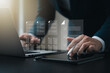 © Thapana_Studio - Business performance monitoring concept, businessman using laptop making correct mark Fill out online surveys, digital form checklists, questionnaires and assessments, blue city background.