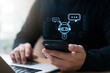 © Thapana_Studio - power of AI enhance your business communication. businessman using Smartphone to connect with AI chatbot, providing intelligent answers to complex questions. Embrace the future of problem solving.