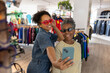© ReeldealHD images - Mother and daughter trying on sunglasses in a vintage thrift store for fun