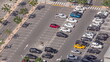 Aerial view of many colorful cars parked on parking lot with lines and markings for parking places timelapse. Dubai