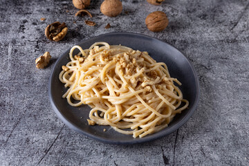 Wall Mural - Spaghetti with walnut cream. Simple, nutritious and tasty dish suitable for those who follow a vegetarian diet.