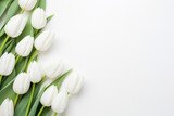 Fototapeta Tulipany - white tulips border on a white background flat lay with copy space, AI generated