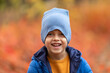 © Irina Mikhailichenko - Close up autumn portrait of a happy cute little boy in autumn park. Preschooler child in fall forest. Bokeh. Selective focus
